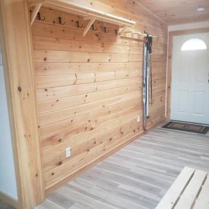 a wooden wall in a garage with a door at Tranquil renovated house in woods - great for families year around in Tannersville