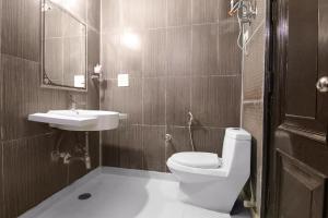 a bathroom with a toilet and a sink at FabHotel Water Vibe in Gurgaon