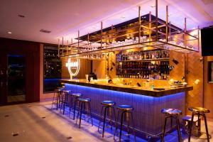 a bar with blue bar stools in a restaurant at President Hotel Udonthani in Udon Thani