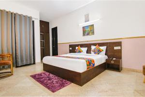 a bedroom with a large bed in a room at FabHotel Water Vibe in Gurgaon