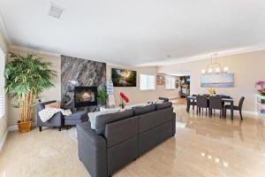 a living room with couches and a dining room at Seabreeze-Modern Home w Outdoor Living&Near Beach in Huntington Beach