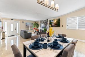 a dining room and living room with a table and chairs at Seabreeze-Modern Home w Outdoor Living&Near Beach in Huntington Beach