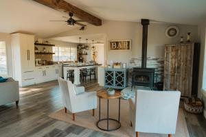 a kitchen with a living room with a stove at Family Farmhouse by Casa Oso with views and spa in Ahwahnee