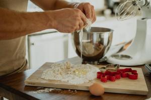 a person is mixing ingredients on a cutting board at Family Farmhouse by Casa Oso with views and spa in Ahwahnee