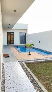 a pool with a palm tree in the middle of a building at شاليهات المرفأ Almarfa Resort in Jeddah