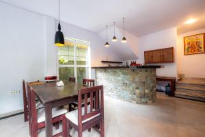 a kitchen and dining room with a table and chairs at Villa Kubu Arya by Supala in Ubud