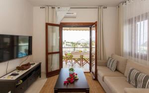 a living room with a couch and a table at Villa Seashell, Private Pool and Magnficent View in Ravdhoúkha