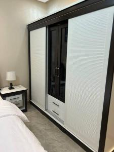 a bedroom with a bed and a large window at غرفة صغيرة ساحرة in Riyadh