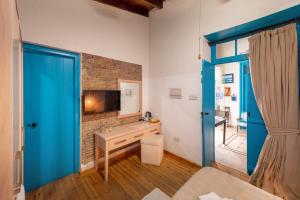 a room with a bathroom with a sink and a tv at Cypriot Swallow Boutique Hotel in Lefkosa Turk
