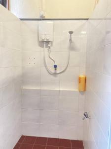 a bathroom with a shower with a shower head at Stop @Melaka Guesthouse in Malacca
