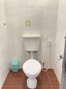 a bathroom with a white toilet and a shower at Stop @Melaka Guesthouse in Malacca