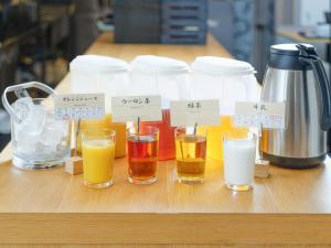 a group of glasses of different types of liquids on a table at APA Hotel Higashi Shinjuku Kabukicho in Tokyo