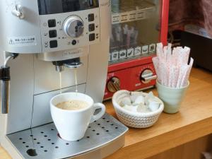 a coffee machine is making a cup of coffee at APA Hotel Higashi Shinjuku Kabukicho in Tokyo