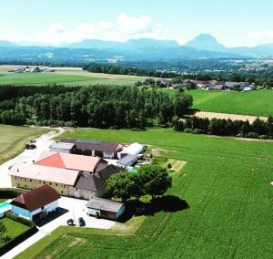 an aerial view of a building in a green field at Vogelhubergut - Familie Scherleithner in Vorchdorf