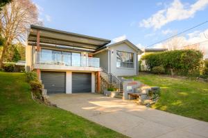 a house with a garage and a grass yard at 13 Mountbatten in Bright
