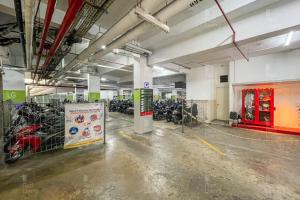 a parking lot with motorcycles parked in a building at RedLiving Apartemen Parahyangan Residence - Anton Rooms in Bandung