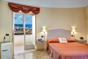 a bedroom with a bed and a large window at Casa Nannina in Meta