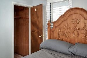 1 cama con cabecero de madera en una habitación en This little house close to hospital,downtown & CFD en Cheyenne