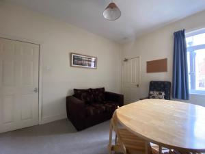 a living room with a table and a couch at Nice Living Serviced Accommodations 5 in Coventry