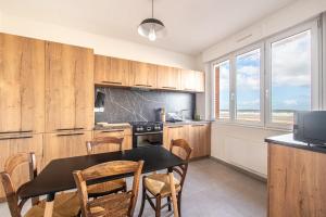 a kitchen with a table and chairs in a kitchen at Banc des Flandres in Bray-Dunes