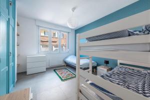 a room with two bunk beds and a window at Banc des Flandres in Bray-Dunes
