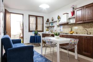 a kitchen with a white table and chairs at Affittacamere Al Mare in Oristano
