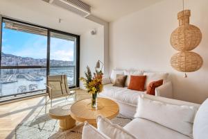 a living room with a couch and a table at La Sentinella - Appt au dessus du Vieux Port in Marseille