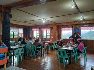 a group of people sitting at tables in a restaurant at Las vegas lodge and restaurant in Banaue