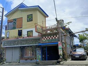 a yellow building with a balcony on top of it at Las vegas lodge and restaurant in Banaue