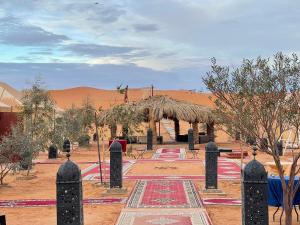 a view of a desert with a building in the background at Roses desert camp in Merzouga