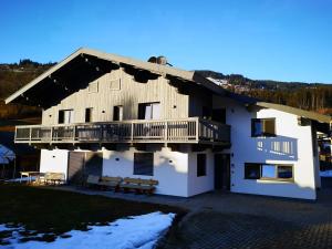 a large building with a porch and a deck at Apartment Sepp in Brixen im Thale