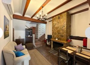 Casa Bella في Bolbaite: غرفة معيشة مع أريكة ومدفأة