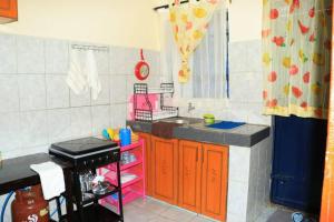 a toy kitchen with a sink and a stove at EuphGlory Accomodations in Kakamega