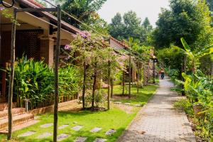 um caminho num jardim ao lado de uma casa em The Garden House Phu Quoc Resort em Phu Quoc