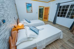 Postel nebo postele na pokoji v ubytování Paradise Breeze Apartment