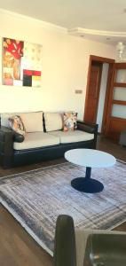 a living room with a couch and a table at Apartman dairesi in Balcova