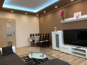 a living room with a large television and a table at Apartment TT11 in Trnava