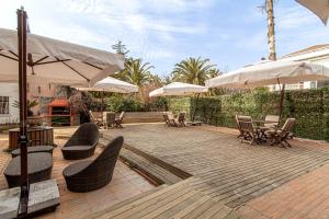 a patio with tables and chairs and umbrellas at Stylish Studio in Historic Mansion in Beylerbeyi in Istanbul