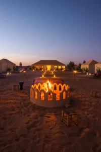 a barrel in the middle of the desert at night at Beldi camp in Merzouga