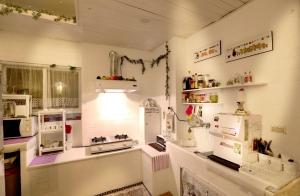 a kitchen with white appliances on the wall at Green Fu Spa Homestay in Kaohsiung