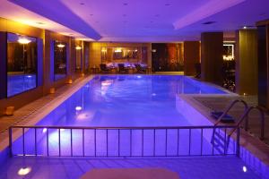 a large swimming pool in a hotel with purple lighting at Grand Halic Goldenhorn in Istanbul