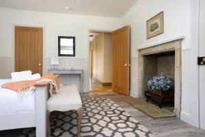 a living room with a bed and a fireplace at The Lodge At Gilmerton House, North Berwick in North Berwick