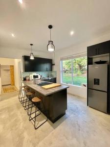 a large kitchen with a counter and a refrigerator at Living The Breede-Lorigan House in Malgas