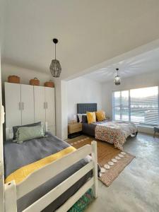 a bedroom with two beds and a couch at Living The Breede-Lorigan House in Malgas