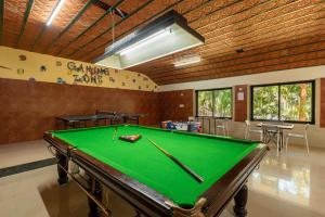 a pool table in a room with a ping pong ball at Nihita I Yoga, Spa, retreat in Dod Ballāpur