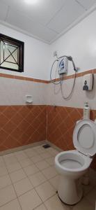 a bathroom with a toilet and a shower at A'Famosa Private Pool 1305 & 935 in Kampong Alor Gajah