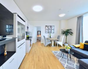 a living room with a couch and a table at Skyscraper-Feeling With Parking Nearby in Vienna