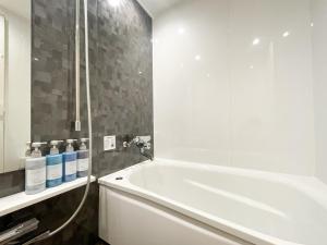 a bathroom with a white tub and a shower at Hotel DIAMOND in Tokyo