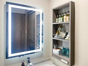 a bathroom with a mirror over a sink with a sink at Hotel DIAMOND in Tokyo