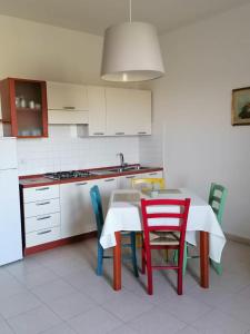 a kitchen with a table and chairs and a stove at Monica appartamenti in San Vincenzo +35 photos